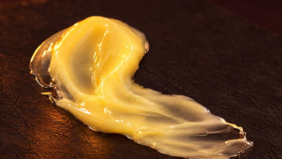 A soft golden swirl of Skin Firming Cream